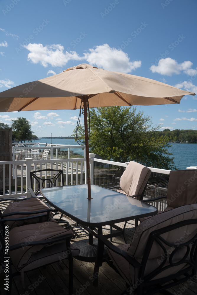 Outdoor patio dining table with waterfront view at a cottage