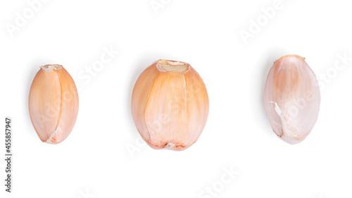 Top view fresh peeled garlic cloves on white background.