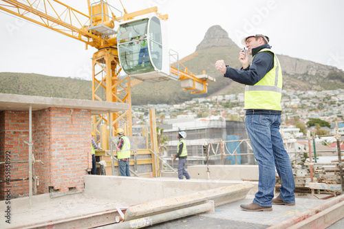 Construction worker with walkie-talkie at construction site