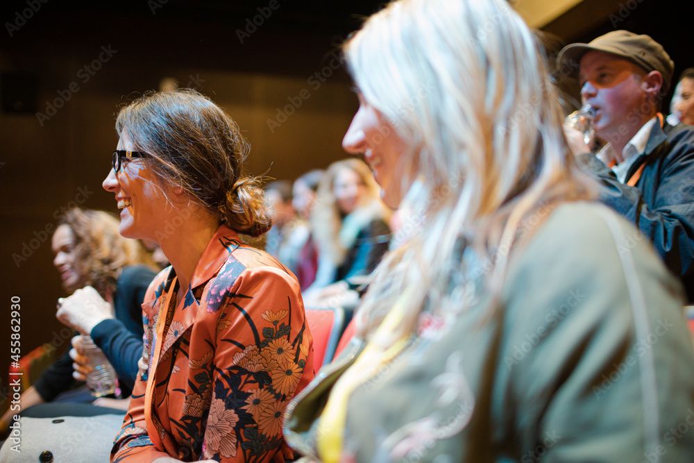Businesswomen talking in conference audience Businesswomen talking in conference audience