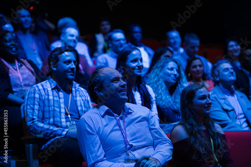 Happy audience in dark room