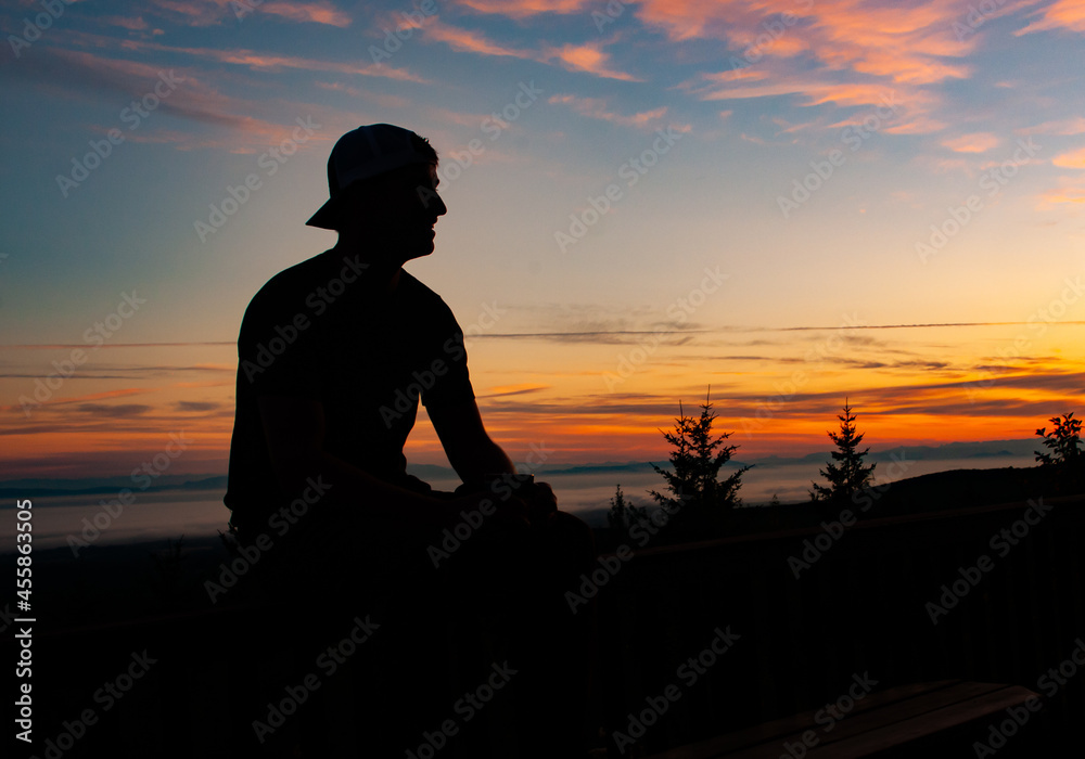 Silhouette of Man in Sunset in Mountains