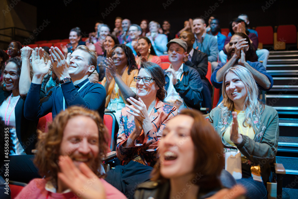 Smiling, excited audience cheering Stock Photo | Adobe Stock