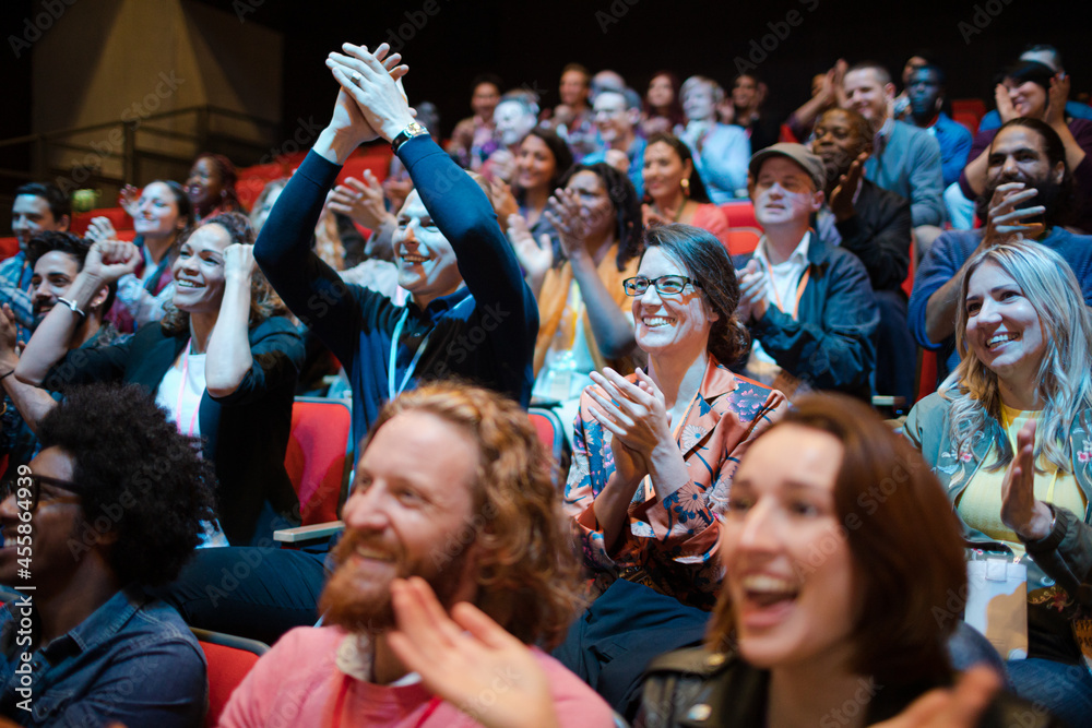 Smiling, excited audience cheering Stock Photo | Adobe Stock