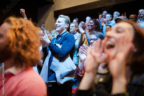 Fotografie Smiling, enthusiastic woman cheering in audience