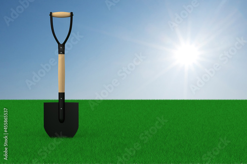 Green meadow and shovel on ...