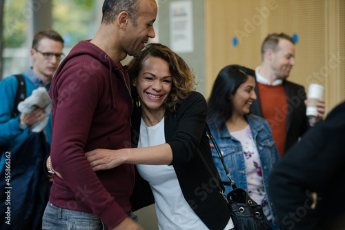 People greeting in hall of auditorium