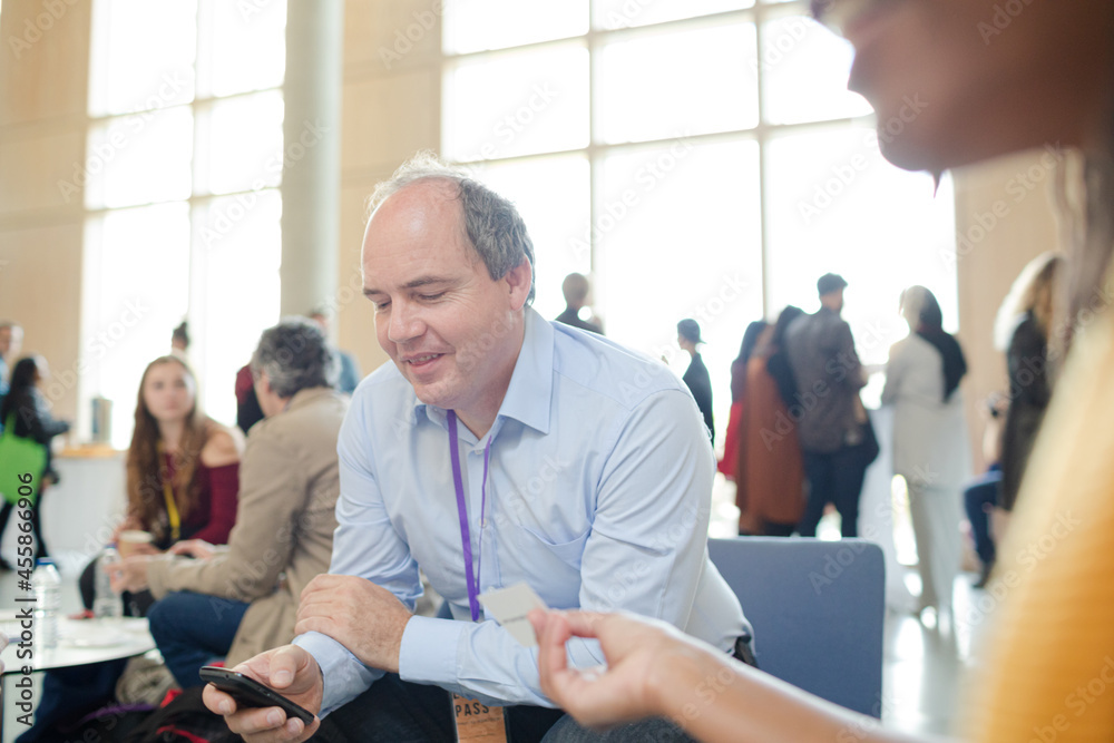 Fototapeta premium People playing cards during conference break