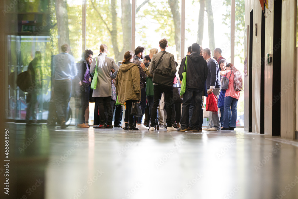 People talking in hall of auditorium