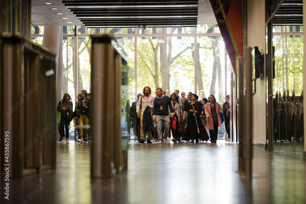 Fototapeta premium People entering auditorium hallway
