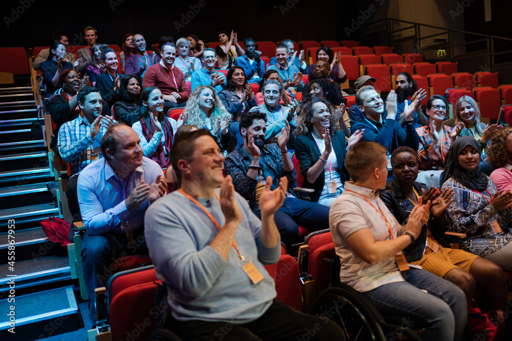 Audience clapping in dark room Audience clapping in dark room