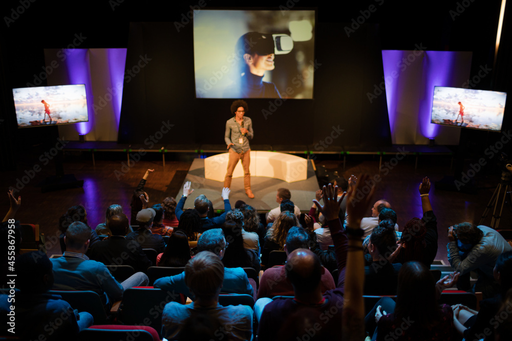 Naklejka premium Audience watching male speaker on stage
