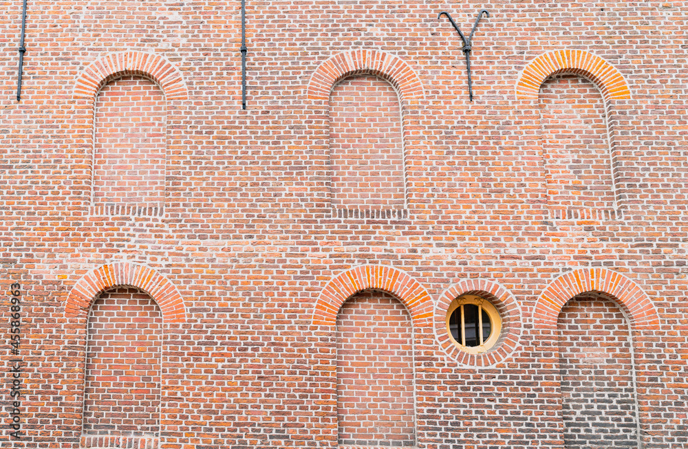 Brick wall with circular window and arched alcoves Stock Photo | Adobe ...
