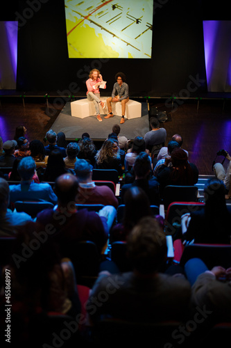 Audience watching speakers talking on stage