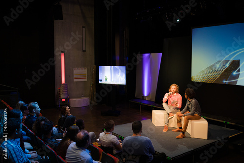 Audience watching speakers talking on stage