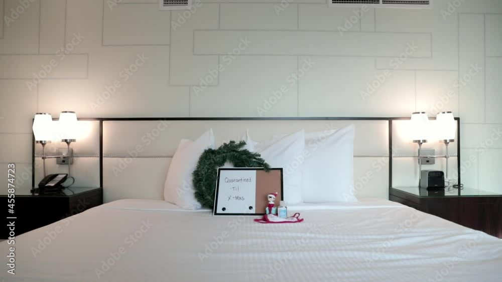 Quarantined Until X-Mas Sign on hotel room bed Quarantined Until X-Mas Sign on hotel room bed