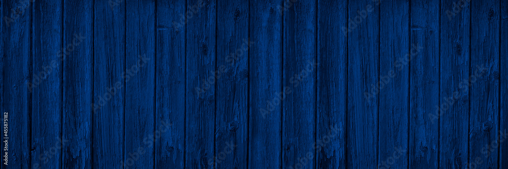 Dark blue wood background with copy space for design. Wide banner. Painted wood planks. Dark blue wood background with copy space for design. Wide banner. Painted wood planks.