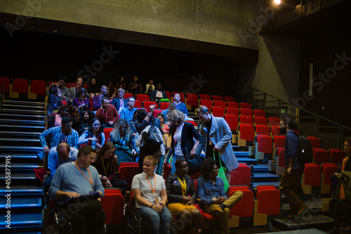 Audience entering dark auditorium
