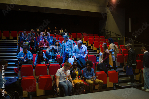 Audience entering dark auditorium