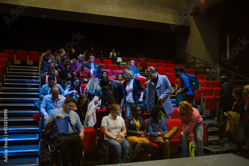 Audience entering dark auditorium