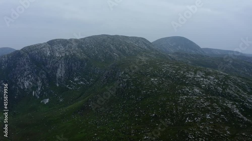Poisoned Glen, Dunlewey, Gweedore, County Donegal, Ireland, September 2021. Drone tracks southwest across misty rugged hills in the Derryveagh Mountains. photo