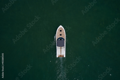 Motor boat top view. Aerial view of a boat in motion turquoise water.