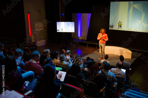 Male speaker on stage talking to audience