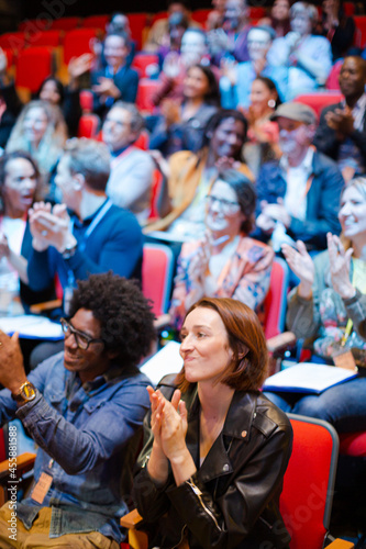 Smiling, happy audience clapping