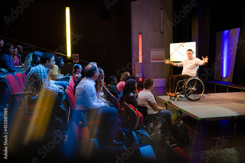 Canvas Print Audience watching male speaker in wheelchair talking on stage