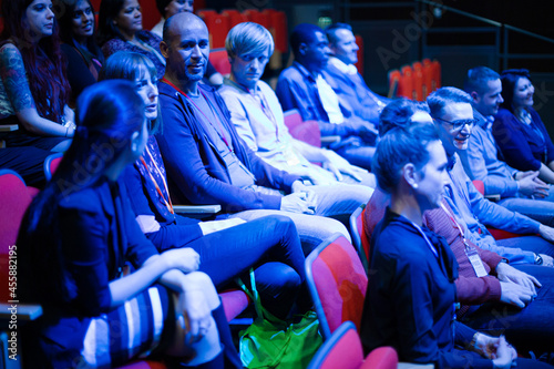 Audience clapping in dark room