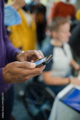 Man using smart phone during conference