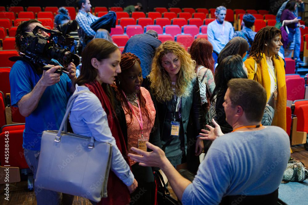 Fototapeta premium Audience talking to speakers in wheelchairs on stage
