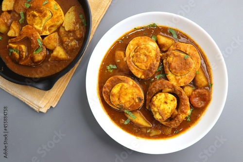 Indian non-vegetarian food- Homemade Egg Curry or Anda masala gravy, baida curry. Indian spicy food. Perfect Indian lunch. over moody background with copy space.