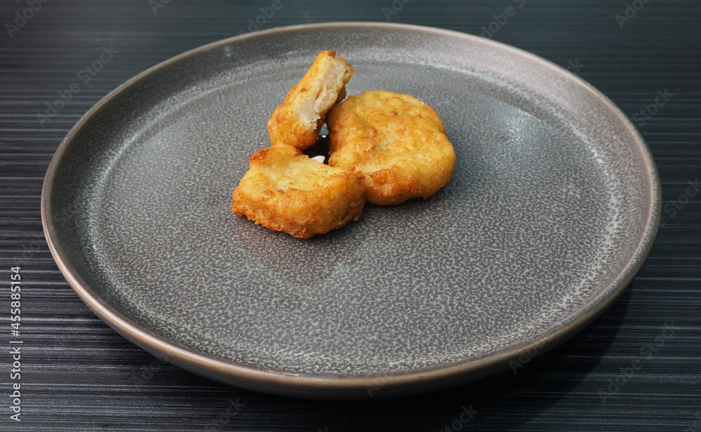 deep fried golden chicken nugget fritter with sauce on dark grey wood background asian dim sum halal food restaurant cuisine banquet menu for cafe