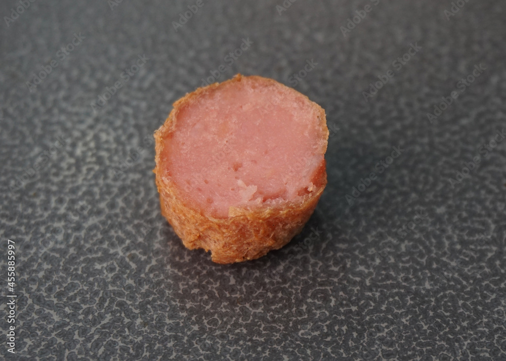 deep fried mini hot dog sausage luncheon meat with spicy sauce on dark grey wood background dim sum halal menu deep fried mini hot dog sausage luncheon meat with spicy sauce on dark grey wood background dim sum halal menu