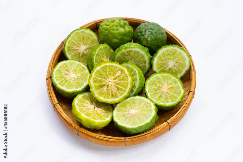 Bergamot kaffir lime in bamboo basket on white Bergamot kaffir lime in bamboo basket on white