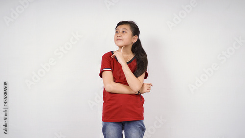 cute little girl thinking of a good idea isolated on white background