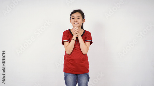 Photography Asian little girl begging for a wish smiling on white background isolated