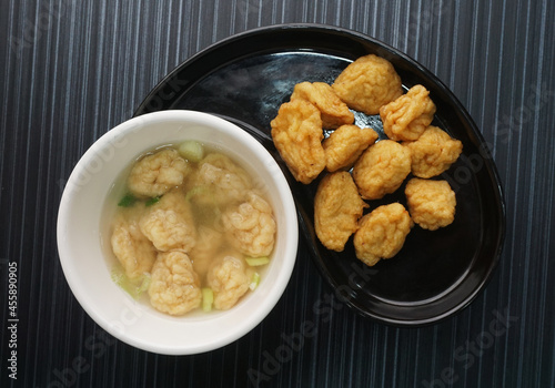 deep fried golden fish prawn ball seafood in dry or soup bowl on dark grey wood background asian dim sum halal food restaurant cuisine banquet menu for cafe