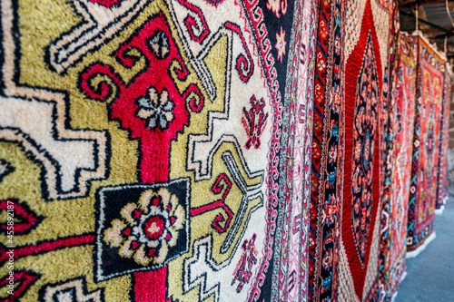 A lot of carpets are drying in the sun. Bright colors and abstract patterns © EdNurg