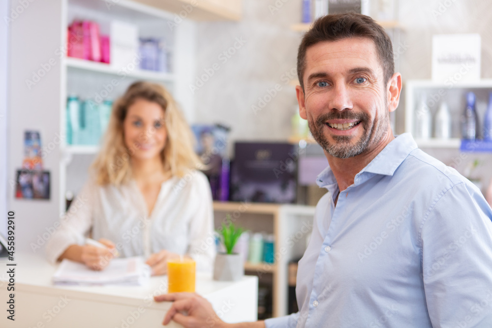 customer and client at reception in a beauty parlour customer and client at reception in a beauty parlour