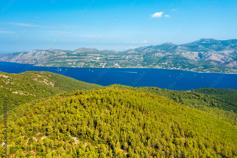 Aerial view of the forested coastline in Korcula island with a view to Peljesac peninsula, Croatia