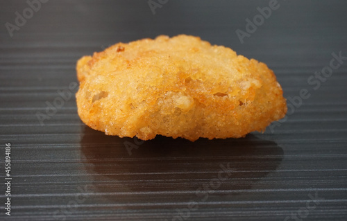 Japanese crispy deep fried tatsuta chicken nugget on dark grey wood background dim sum halal menu photo