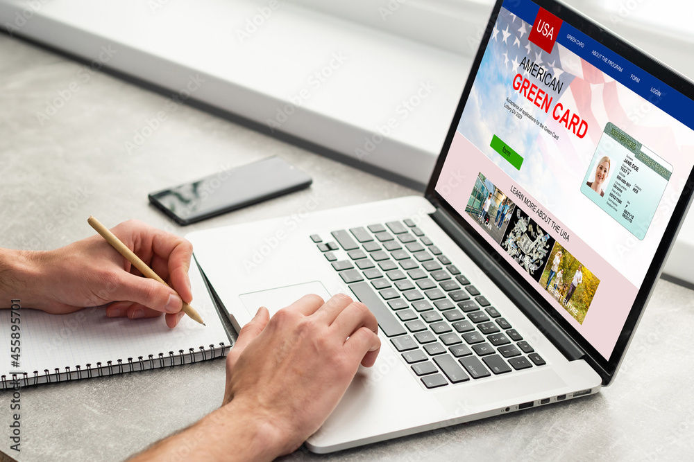 man with laptop with United States Permanent Resident Card website man with laptop with United States Permanent Resident Card website