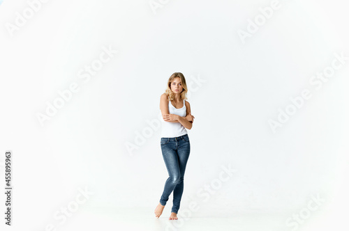 blonde in a white t-shirt barefoot on the floor movement emotions positive