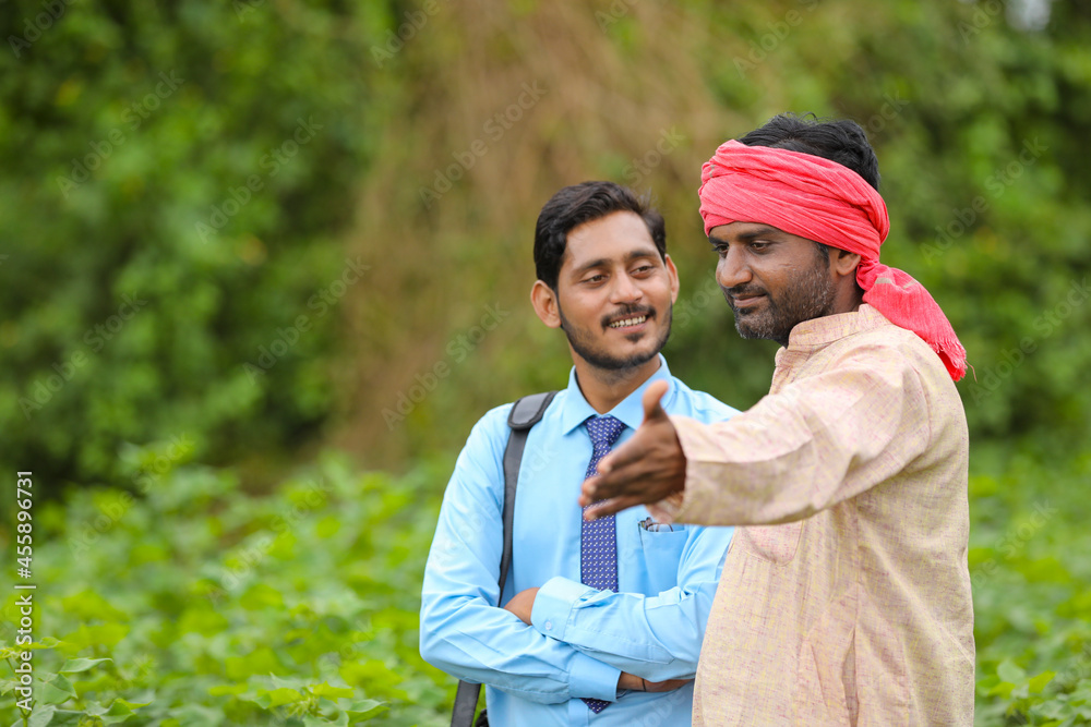 Indian farmer Discussing with agronomist at Farm and collecting some information Indian farmer Discussing with agronomist at Farm and collecting some information