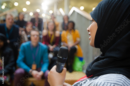 Female speaker in hijab talking to audience