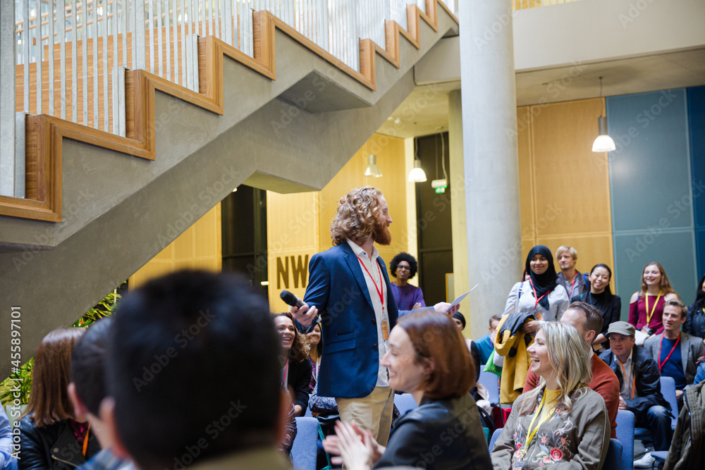 Audience watching male speaker