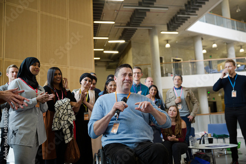 Speaker in wheelchair talking to audience