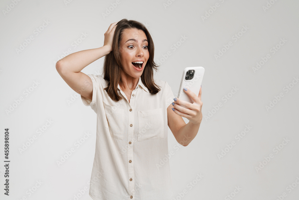 Young woman holding her head while using cellphone Young woman holding her head while using cellphone